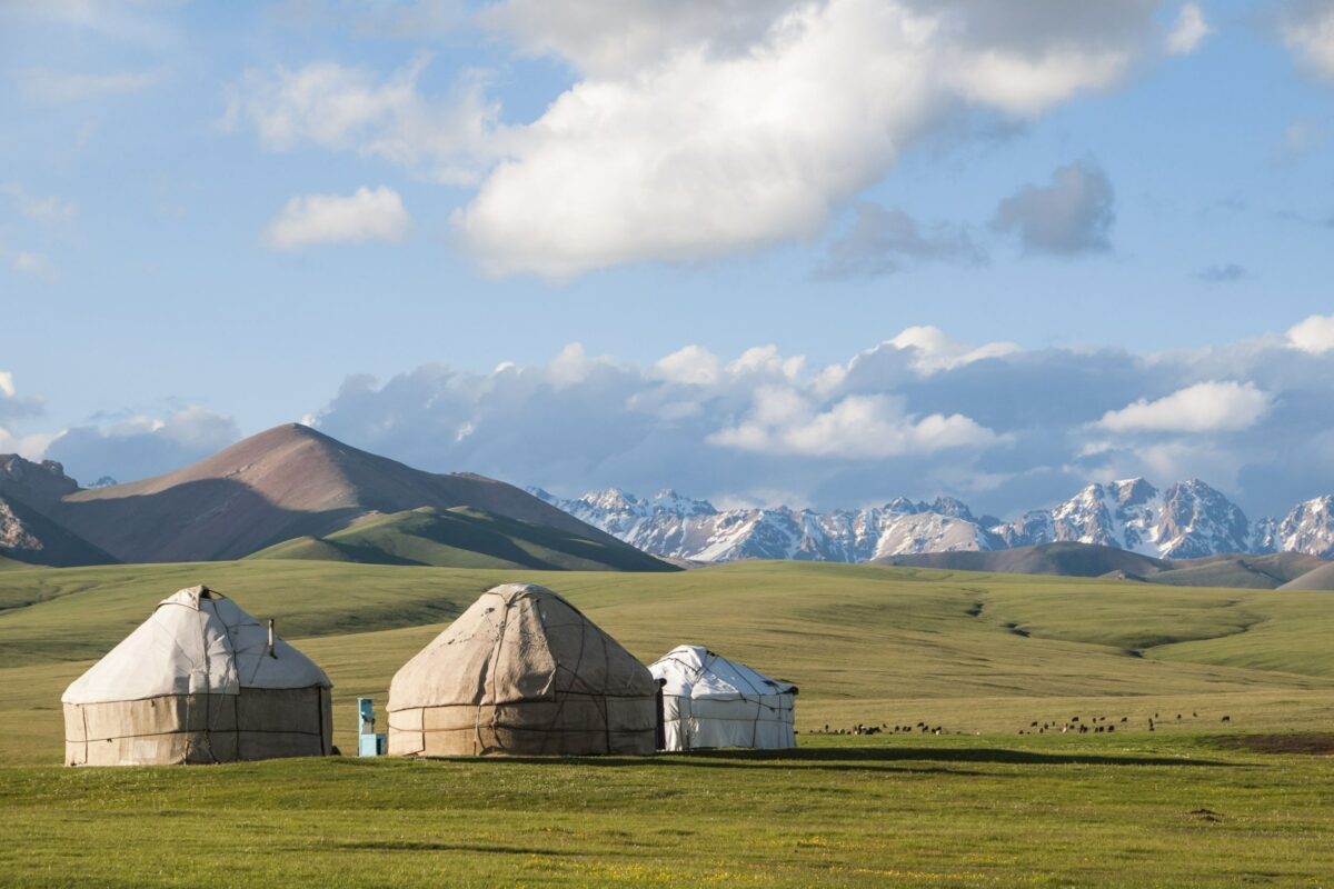 Kyrgyzstan yurts background of mountains in Songköl Lake area