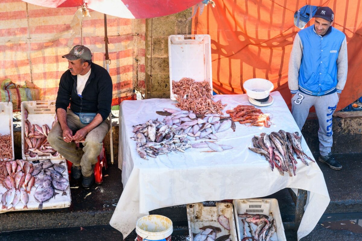 Morocco Essaouria Moroccan local men sell fresh fish and seafood on the market in port