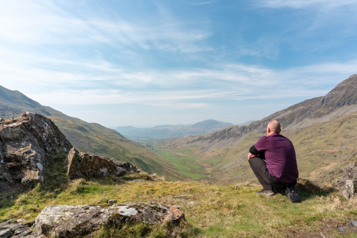 Snowdonia Way walker admiring the view of Cwm Croesor from Cnicht Gwynedd Wales uk