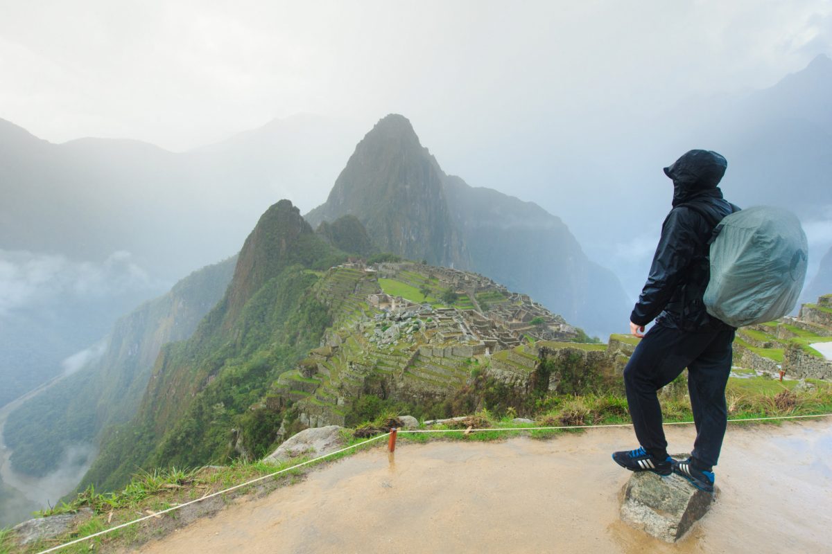 Tourist looking over Machu Picchu Peru